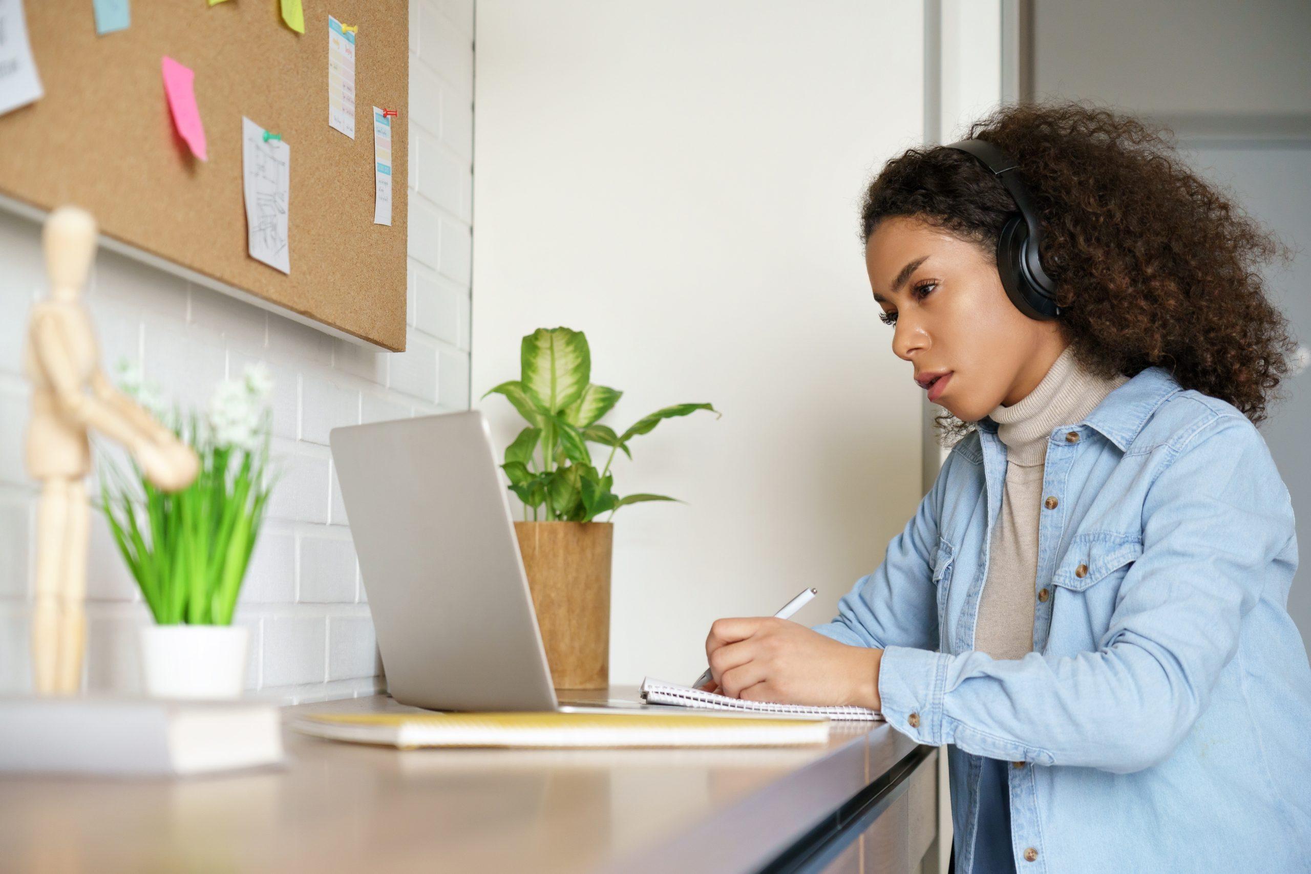 African teen girl college student, school pupil, remote worker learning with online tutor studying at home office desk watching web class, make video conference call on computer, distance elearning.